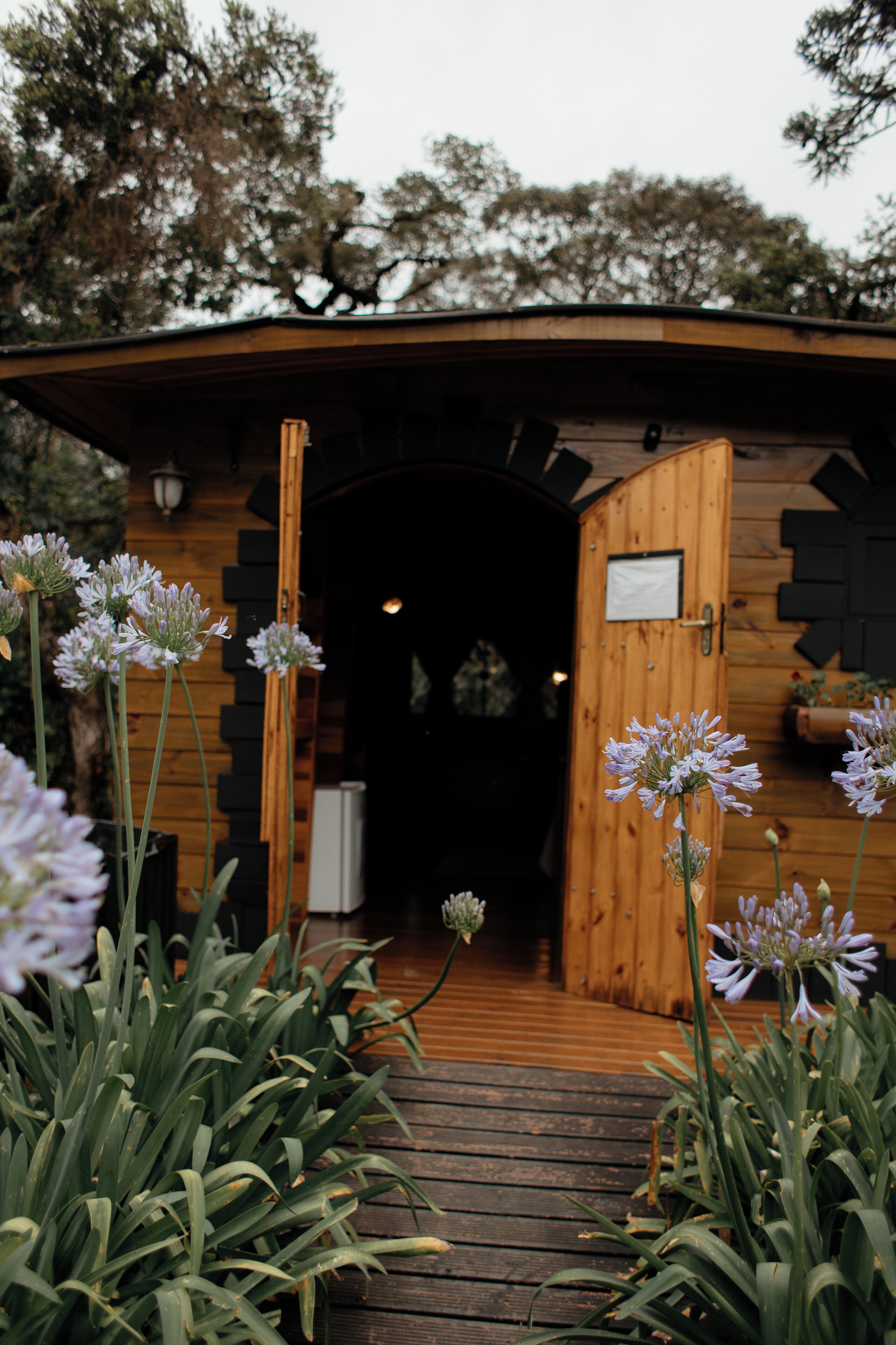 A wooden cabin entrance with a wooden door and a small porch area.