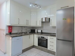Enjoy cooking in this well-equipped kitchen with an oven, microwave, and ample workspace.
