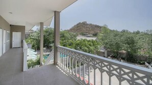 A balcony with a view of a hill and greenery. - Blue Horizon (Hua Hin)