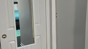 A white door with a mirror, a plain wall, and a dark carpeted floor. - 2 Pvt bed Rm 1bathroom no kitchen attic (Uniondale)