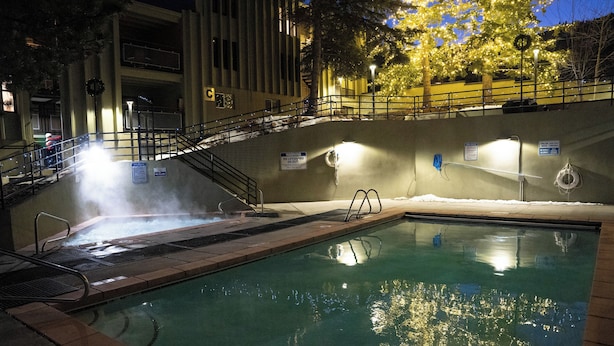 An indoor swimming pool with a hot tub, stairs, and a railing. - Edelweiss MTN Haus, Summer Base Camp Steps from PCMR, Pool, Hot Tub. Local Hosts (Park City)