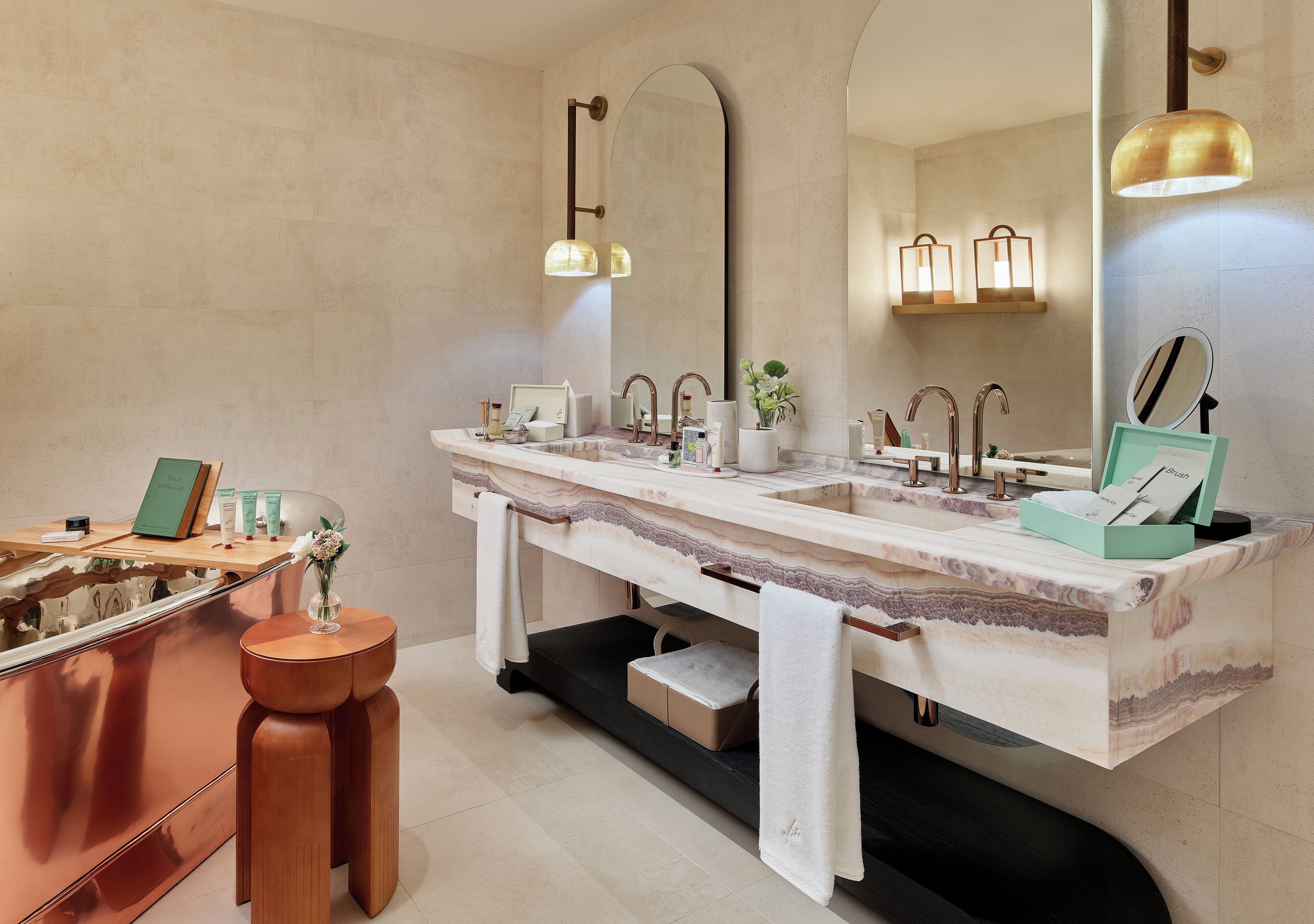 A modern bathroom with a large mirror, two sinks, and a vanity area.