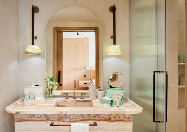 A bathroom with a marble countertop, a sink, a mirror, and two pendant lights. - Aliée Istanbul - A Paris Society Collection Hotel (Istanbul)