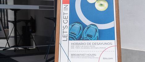 Ein Schild mit Frühstückszeiten und Abfahrtszeiten für ein Restaurant.