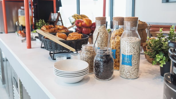 A breakfast buffet with various food items and containers.