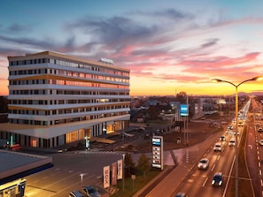 A modern hotel with a flat roof, multiple floors, and a parking lot. - Novotel Zagreb - opened September 2025 (Zagreb)