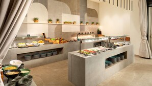 A modern buffet setup with various food stations, including fruits, vegetables, and prepared dishes. - Novotel Zagreb - opened September 2025 (Zagreb)
