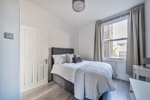 1 bedroom, desk, iron/ironing board, travel crib