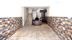 A reception area with a tiled floor and a reception desk.