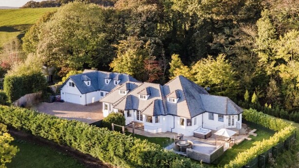A large estate with multiple buildings, a well-maintained garden, and a vineyard.