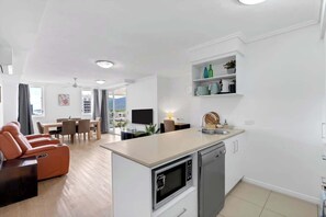 Un appartamento moderno con cucina, zona pranzo e soggiorno.