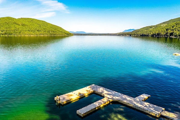 Guests can enjoy serene lake views from a wooden dock.