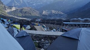 A mountainous campsite with tents and a stone wall. - Neelkanth camp Kedarnath (Kedarnath)