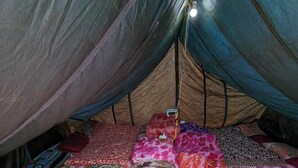 A tent with a sleeping area featuring colorful floral bedding. - Neelkanth camp Kedarnath (Kedarnath)