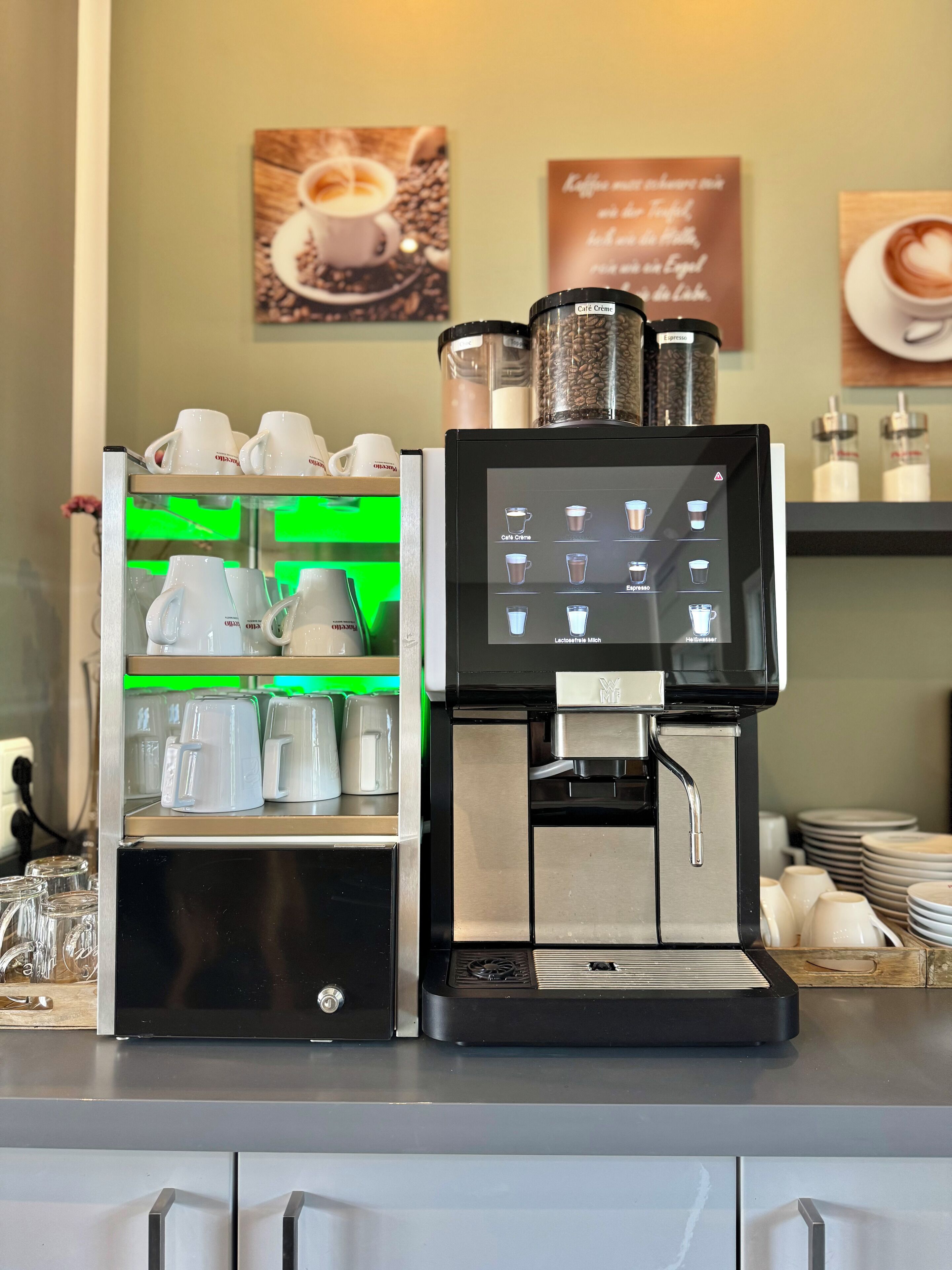 A coffee machine with a digital display and a coffee cup display.