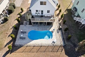 A house with a swimming pool, a covered patio, and a fenced yard. - Hot Tub & Heated Pool!  3min Walk to Beach with Private Dock. Pet Friendly! (Oak Island)
