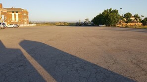 A large parking lot with a building in the background. - Hotel Reina Isabel (Lleida)