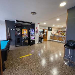 A pool table, dartboards, and a bar area with stools. - Hotel Reina Isabel (Lleida)