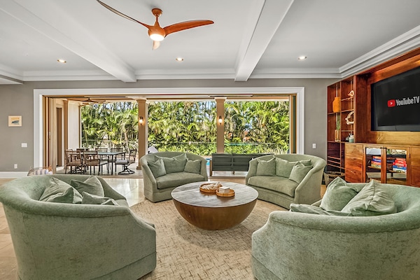 This 5-bedroom villa blends luxury and island charm, with a private heated pool surrounded by lush tropical gardens