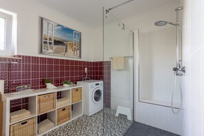 Shower, hair dryer, soap, toilet paper
