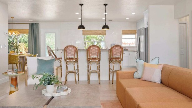 A modern living room with a sofa, chairs, a coffee table, and a dining area with chairs and a table. - 3 Blocks to Beach ☀️ Game room, cabana bar + family fun (Holmes Beach)