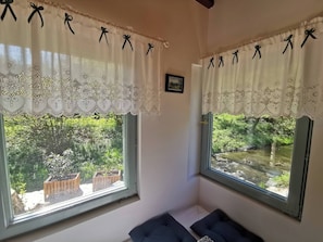 A room with two windows, each with a white curtain featuring black bows and a lace trim. - Fairy Tale Cottage on Water Stream, 30 Minutes From South Prague (Petrov)