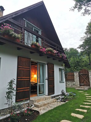 A two-story house with a balcony adorned with potted plants. - Fairy Tale Cottage on Water Stream, 30 Minutes From South Prague (Petrov)