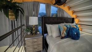 A bedroom with a bed, bedside table, lamp, and curtains. - Jesus did it, Christian Paradise with jacuzzi, terrace, and peaceful atmosphere. (Patillas)