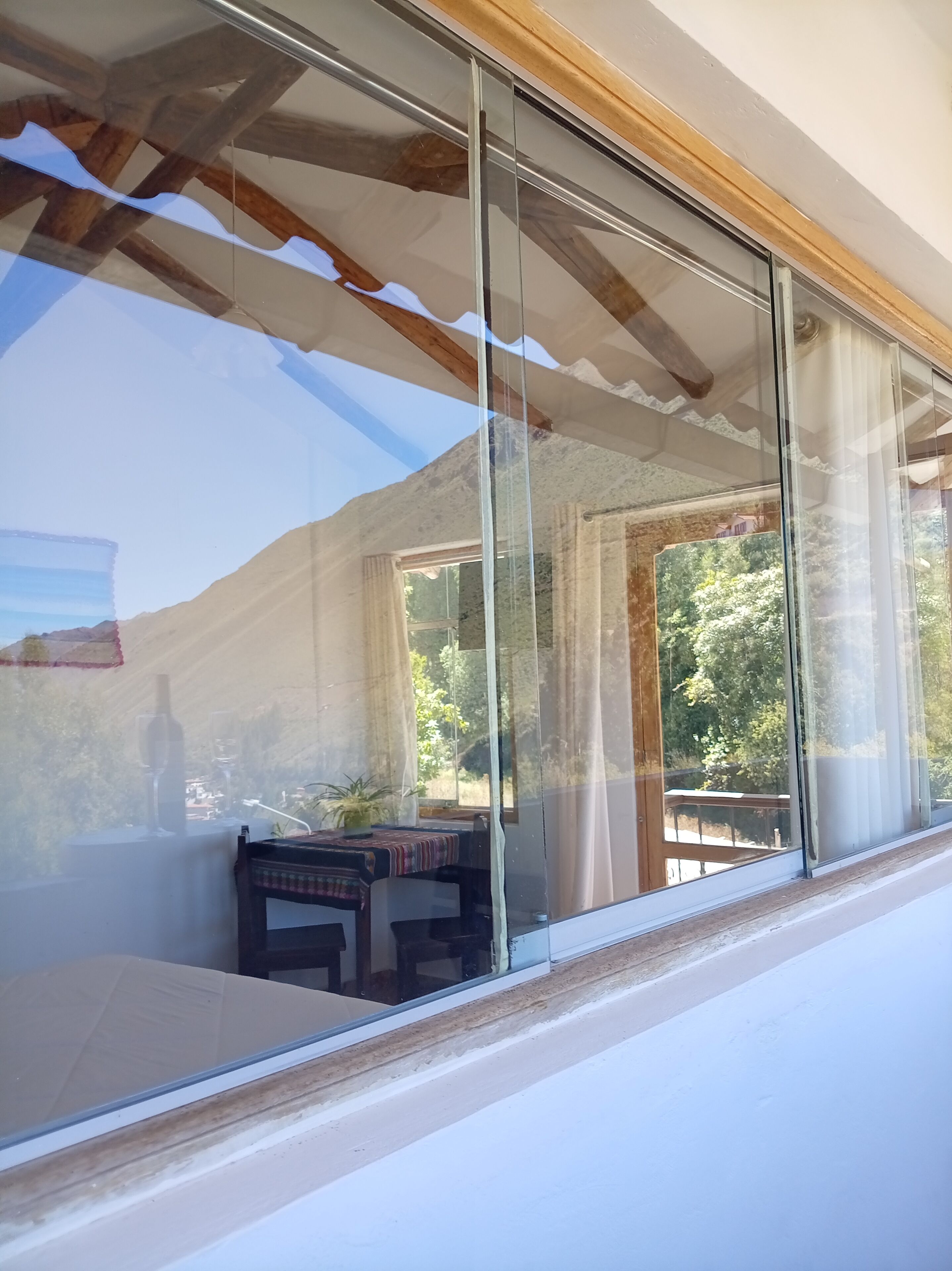 A room with a large sliding glass door leading to an outdoor area with a table and chairs.