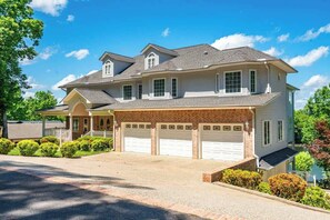 A two-story house with a garage, a covered porch, and a landscaped front yard.