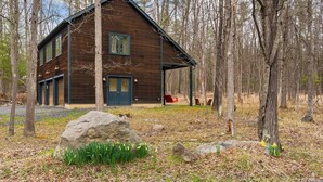 A wooden cabin with a porch, large windows, and a door. - Pool+hot Tub, Firepit Near Hikes, Shops, Dining Cragswood Lodge by Avantstay (New Paltz)