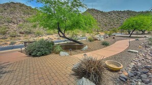 A paved pathway with a cactus garden and a tree-lined area. - Pickleball Court! +GIANT Pool w/Waterslide! Game Room, Hot Tub, Golf+ (Mesa)