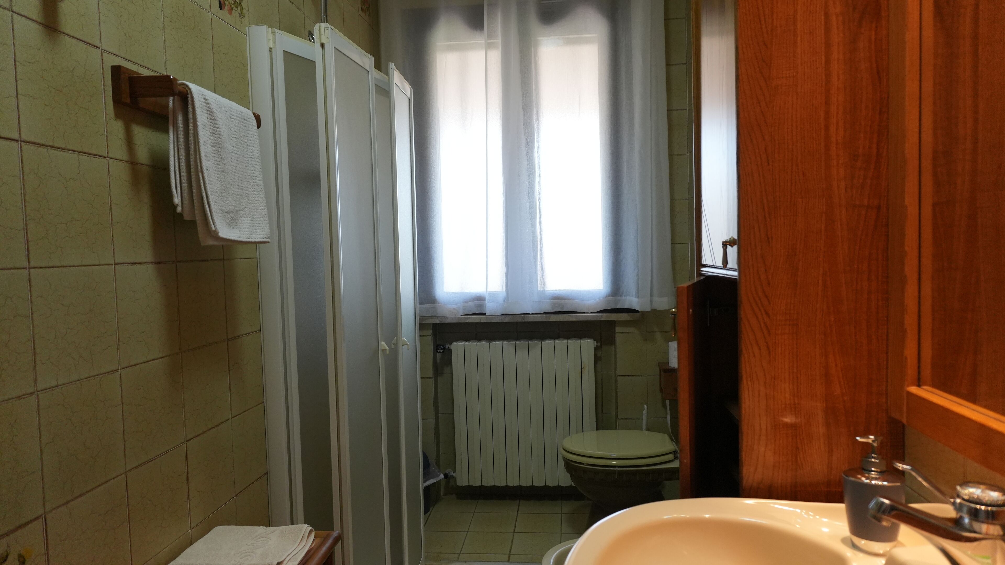 Une salle de bain comprenant des toilettes, un lavabo et un espace douche.