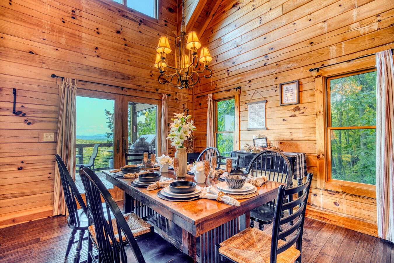 Een houten eetkamer met een grote tafel, gedekt voor zes personen, omringd door stoelen.
