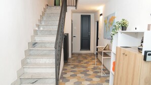 A staircase with marble steps leading to a landing.