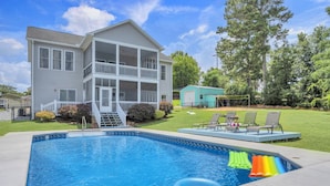 A two-story house with a swimming pool, a covered porch, and a small shed in the backyard. - Lakefront Getaway with Dock, Pool, Sunset Games (Greenwood)