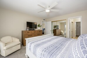 A bedroom with a bed, a ceiling fan, a TV, a dresser, and a chair. - CASA EDEN/Luxury 3 BR Private Townhouse in Scottsdale (Scottsdale)
