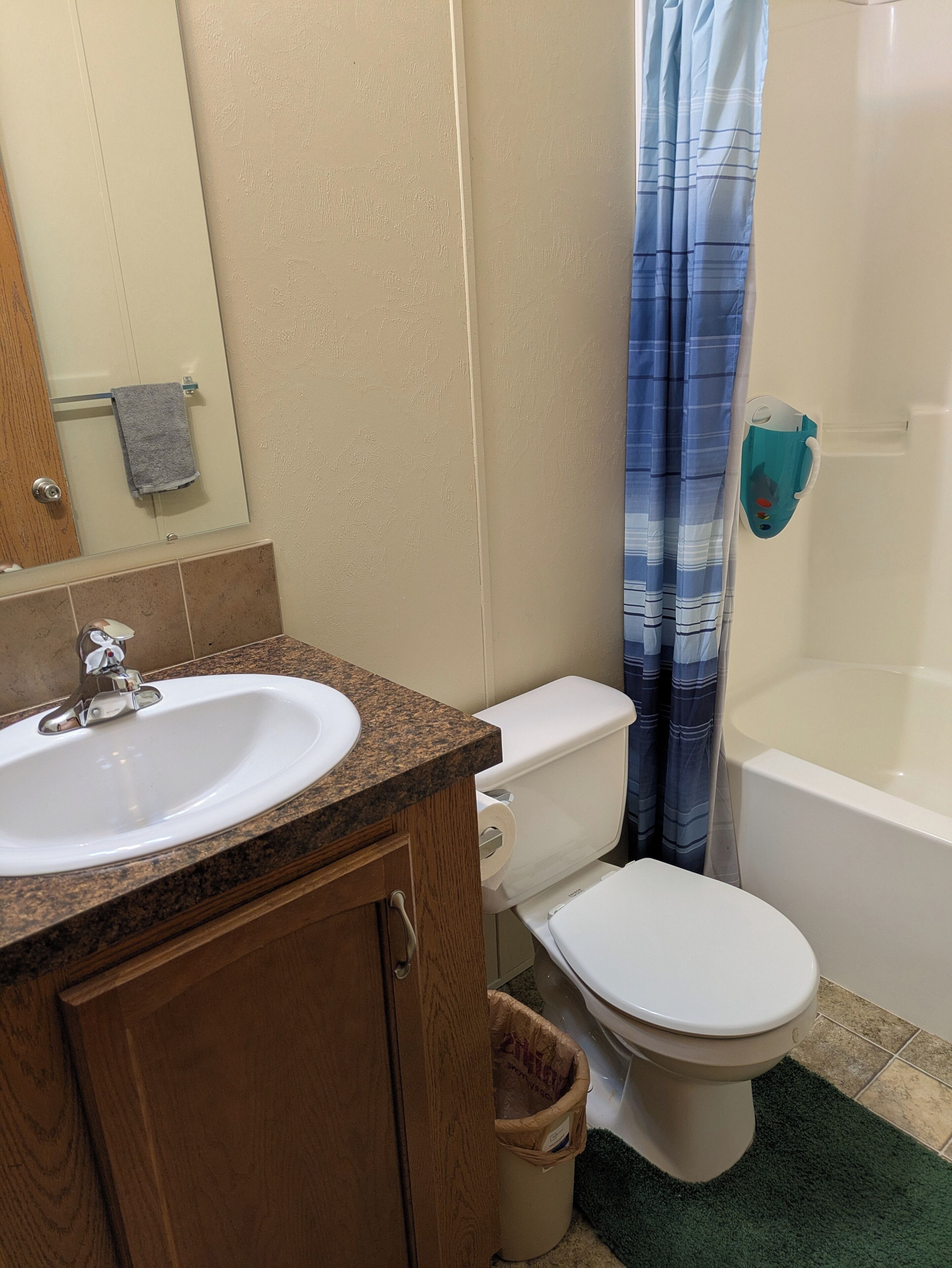 A bathroom with a sink, toilet, and bathtub.