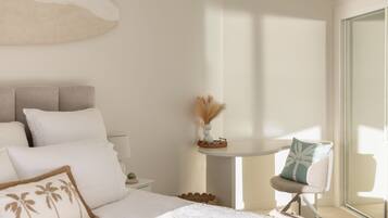 A bedroom with a bed, bedside table, and a chair.
