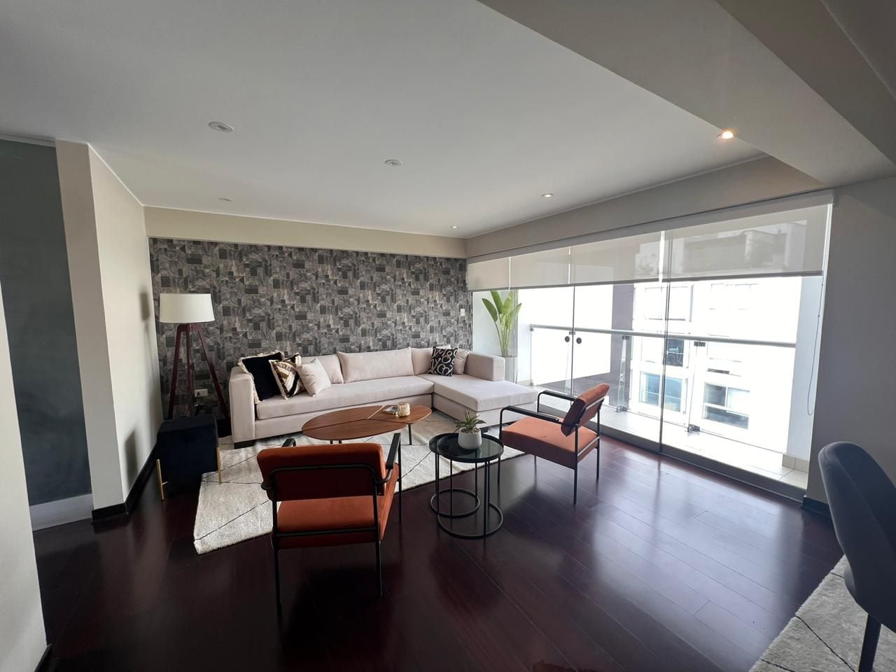 A modern living room with a sofa, coffee table, and chairs.