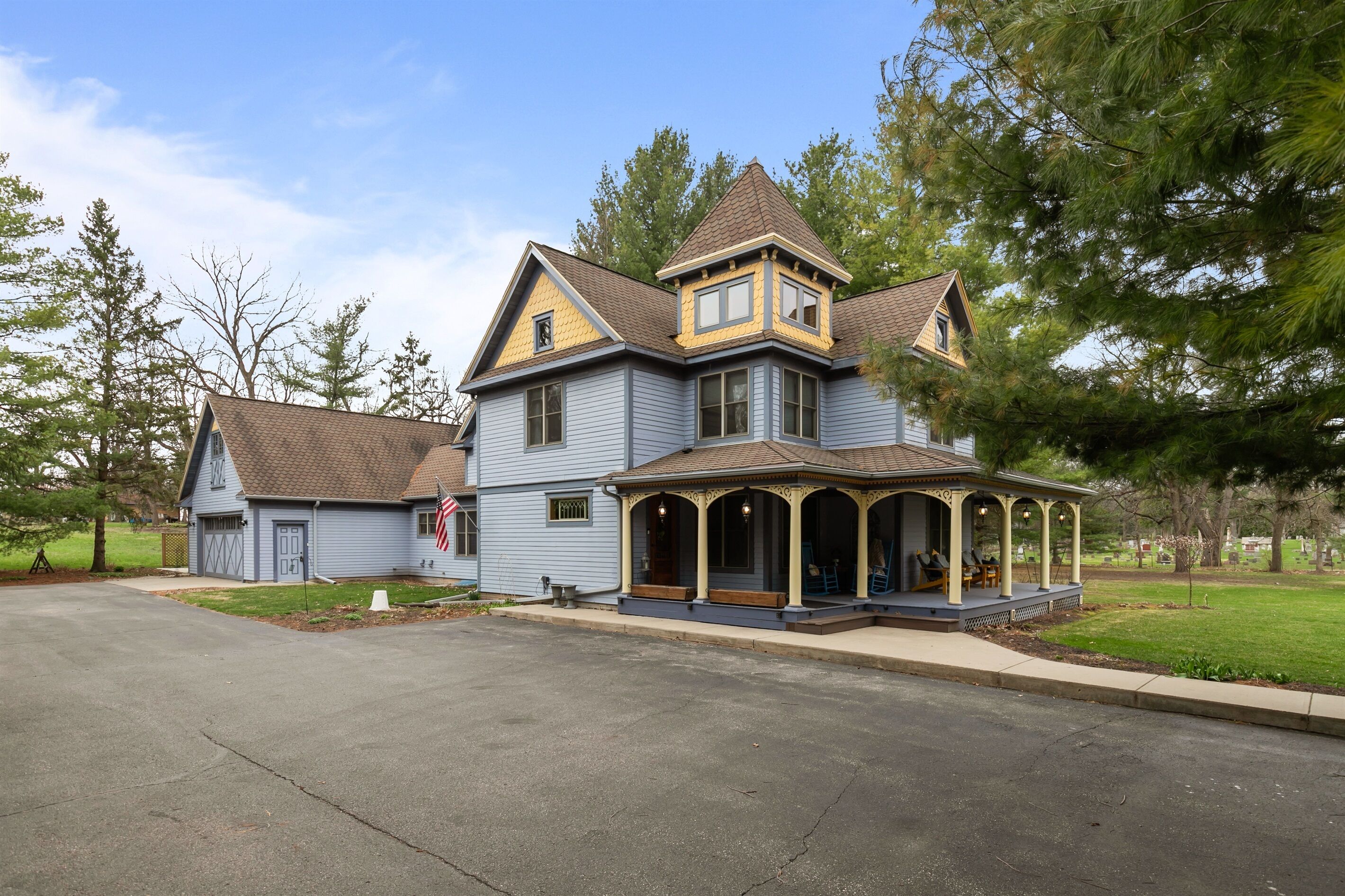 A large, two-story house with a prominent porch and a small attached garage.