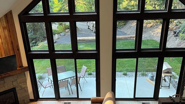 Un salon spacieux doté d’une grande fenêtre, d’une cheminée et d’un coin repas.