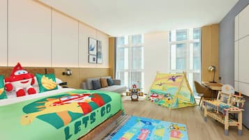 A child's bedroom with a bed, a play area, and a window.