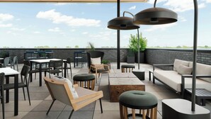 An outdoor patio area with tables, chairs, and a sofa.
