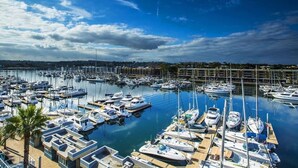 A marina with numerous boats docked at piers.