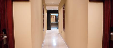 A hallway with numbers 4003 and 4004 on the walls, leading to a door at the end.