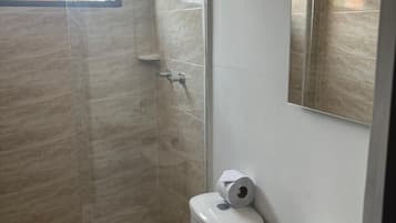 Basic Double Room | Bathroom | Shower, towels, soap, toilet paper