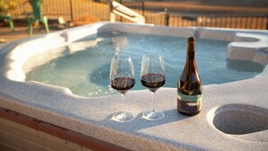 A hot tub with two glasses of red wine and a bottle of Black Orchid wine. - Kiler Ranch House is a charming 3-bedroom house that is ideal for a weekend away (Paso Robles)