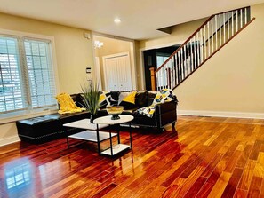 Relax in this inviting living room with a comfortable sofa, coffee table, and potted plant.