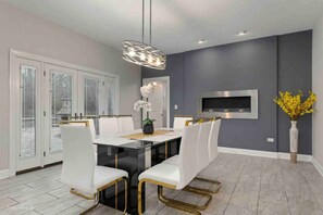 Enjoy meals in this stylish dining area with a glass-top table and comfortable seating for all.